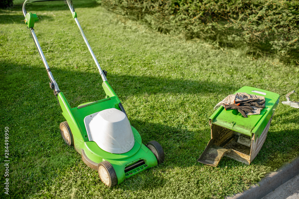 Fototapeta premium Lownmower on the grass outdooors