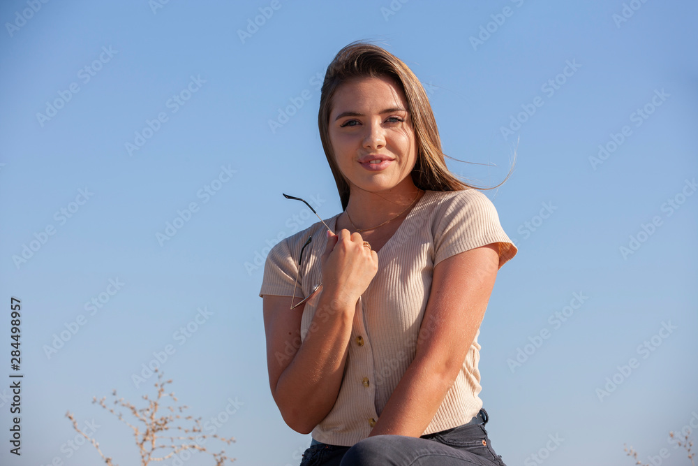 Portrait of a young beautiful brunette woman by the river Portrait of a young beautiful brunette woman by the river