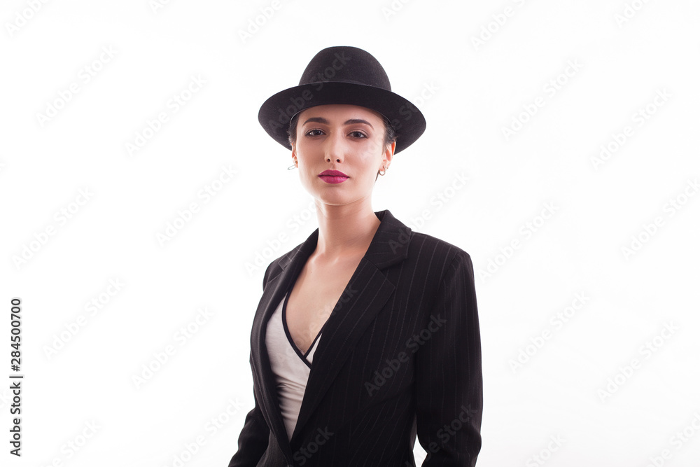 Stylish fashion model wearing a hat over white background in studio Stylish fashion model wearing a hat over white background in studio