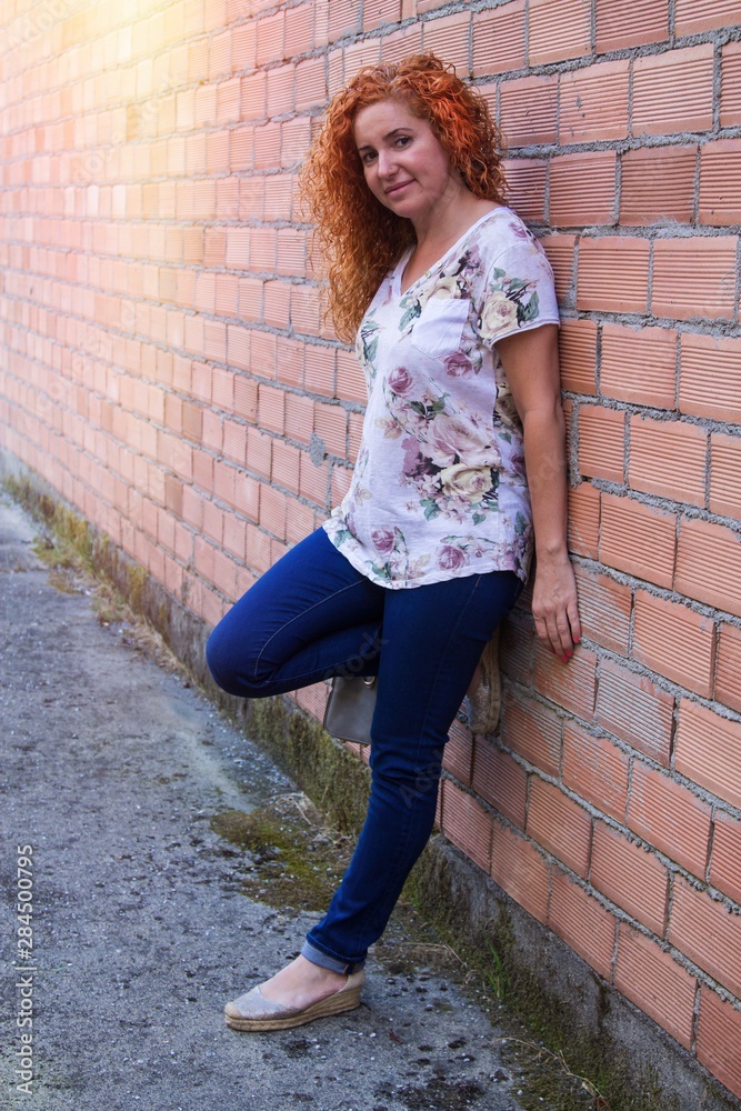 portrait of redhead woman leaning on the wall portrait of redhead woman leaning on the wall