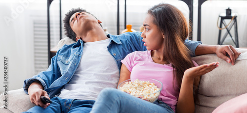Black guy fell asleep during watching boring movie at home
