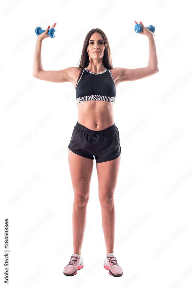 Front view of fitness woman aerobic instructor doing shoulder exercise with dumbbells. Full body isolated on white background. Front view of fitness woman aerobic instructor doing shoulder exercise with dumbbells. Full body isolated on white background.