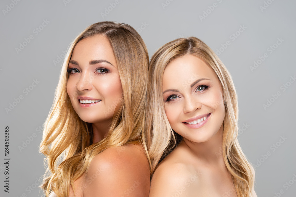 Studio portrait of young, beautiful and natural blond women over grey background. Close-up of smiling girls. Face lifting, plastic surgery, cosmetics and make-up. Studio portrait of young, beautiful and natural blond women over grey background. Close-up of smiling girls. Face lifting, plastic surgery, cosmetics and make-up.