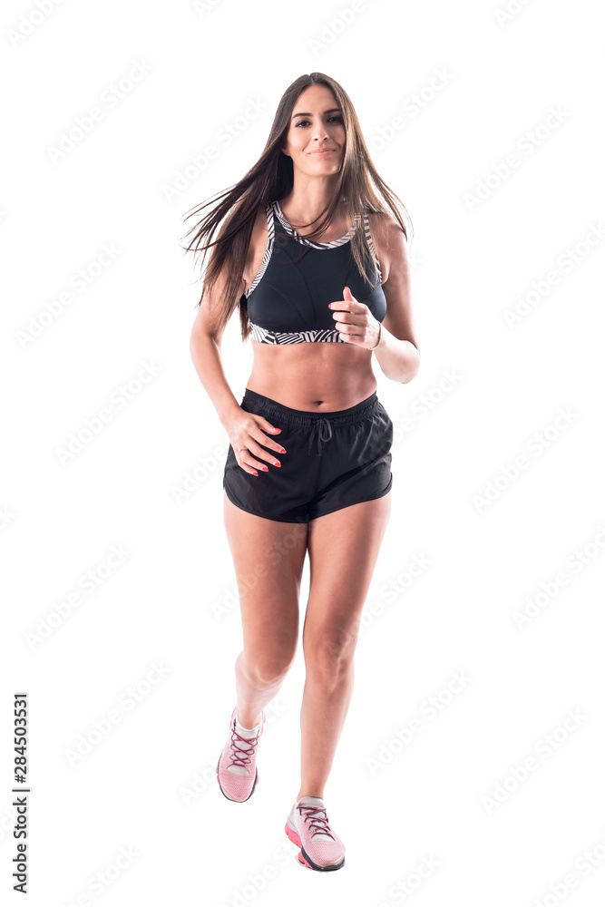 Front view of happy fit active woman in sportswear jogging towards camera. Full body isolated on white background. Front view of happy fit active woman in sportswear jogging towards camera. Full body isolated on white background.