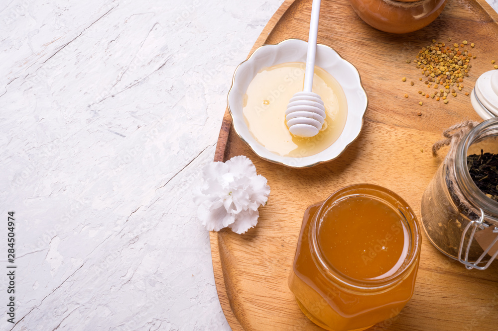 linden honey with perga at wooden tray at white table. copy space. flat lay linden honey with perga at wooden tray at white table. copy space. flat lay