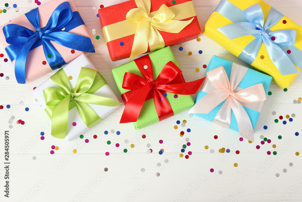 gifts and confetti on a colored background top view. Holiday giving gifts gifts and confetti on a colored background top view. Holiday giving gifts