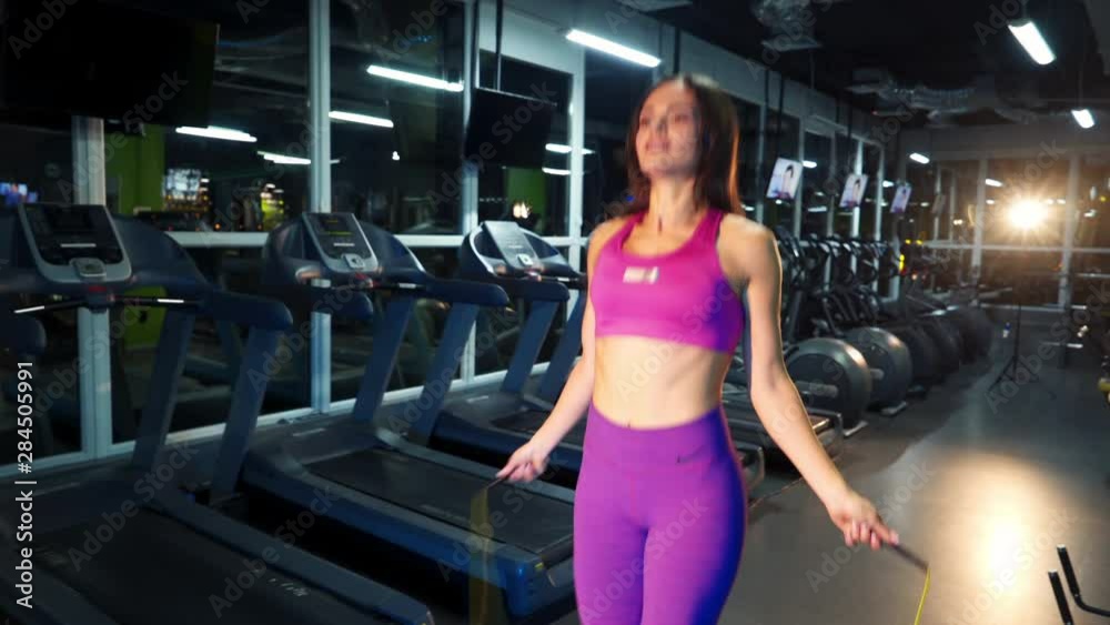 Young Woman Exercising Using Skipping Rope in Gym Young Woman Exercising Using Skipping Rope in Gym