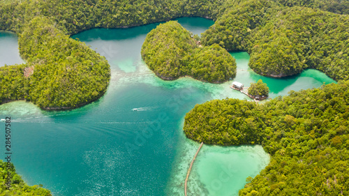 Cove and blue lagoon among small islands covered with rainforest. Sugba lagoon  Siargao  Philippines. Aerial view of Sugba lagoon  Siargao Philippines.