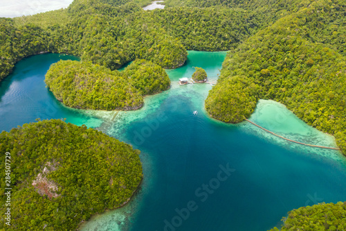 Cove and blue lagoon among small islands covered with rainforest. Sugba lagoon  Siargao  Philippines. Aerial view of Sugba lagoon  Siargao Philippines.