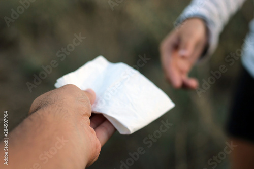 Offering a handkerchief to a woman with a cold.