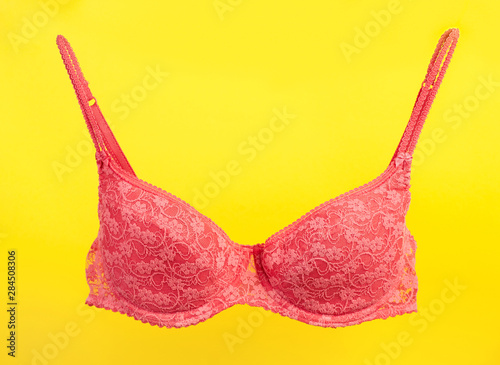 Pink bra on yellow