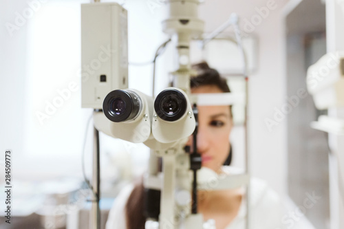 young woman sitting at Ophthalmologist clinic to get her eyes examined by a professional.