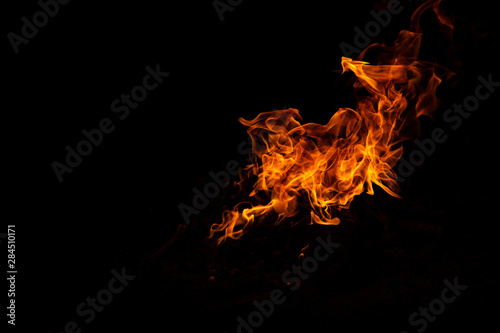 fire burns on a dark background © Юля Стасик