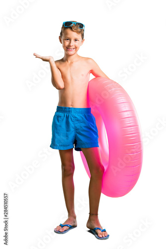 A full-length shot of Child on summer vacation holding copyspace imaginary on the palm on isolated white background