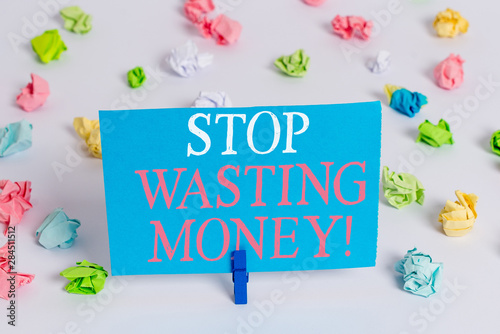 Writing note showing Stop Wasting Money. Business concept for advicing demonstrating or group to start saving and use it wisely Colored crumpled paper empty reminder white floor clothespin © Artur