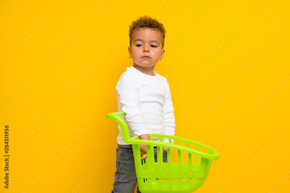 kid over isolated yellow background