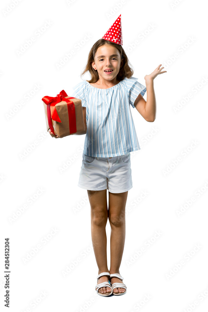 A full-length shot of a Little girl at a birthday party holding a gift with surprise and shocked facial expression on isolated white background A full-length shot of a Little girl at a birthday party holding a gift with surprise and shocked facial expression on isolated white background