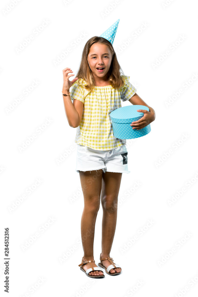 A full-length shot of a Little girl at a birthday party holding a gift annoyed angry in furious gesture on isolated white background A full-length shot of a Little girl at a birthday party holding a gift annoyed angry in furious gesture on isolated white background