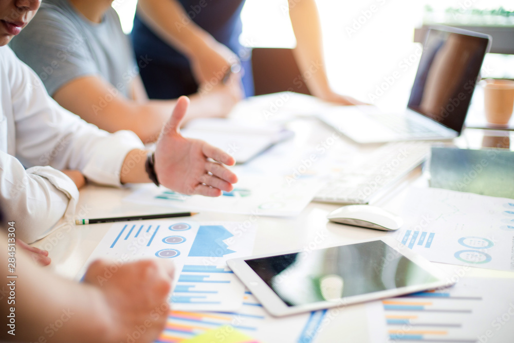 Business group or business partners discussing documents and ideas at meeting