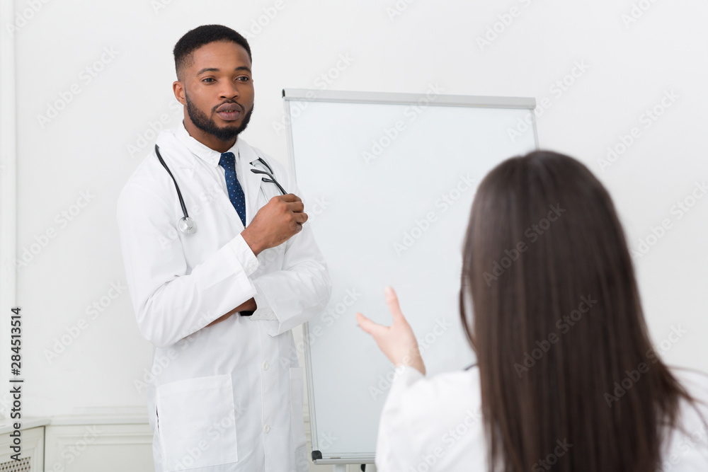 Active intern asking question to practitioner at seminar Active intern asking question to practitioner at seminar