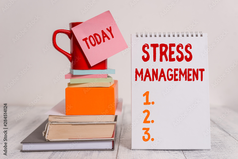 Word writing text Stress Management. Business photo showcasing method of limiting stress and its effects by learning ways Cup sticky note stacked note pads books square box spiral wooden table
