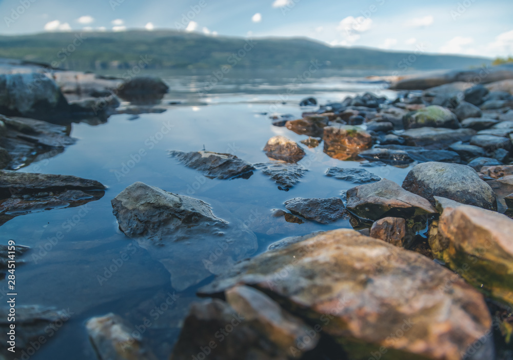 Stones on the shore of the lake, details of nature, soft focus