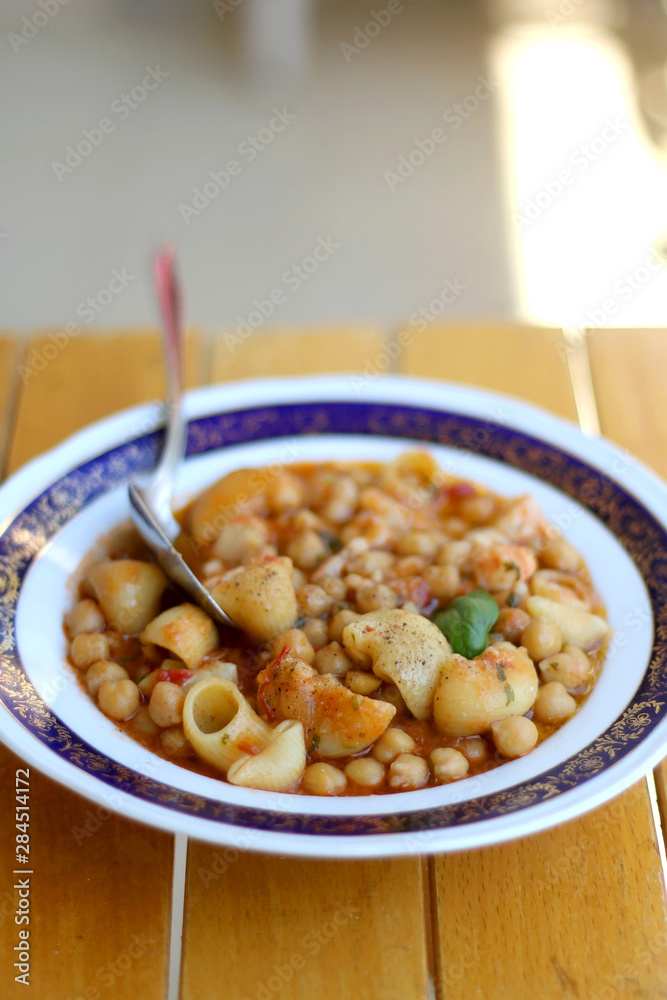 Plate of pasta, chickpea and shrimp stew. Selective focus. Plate of pasta, chickpea and shrimp stew. Selective focus.