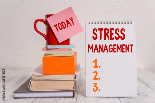 Obraz na płótnie Word writing text Stress Management. Business photo showcasing method of limiting stress and its effects by learning ways Cup sticky note stacked note pads books square box spiral wooden table w salonie
