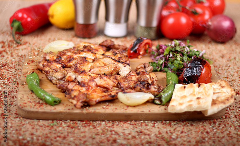 Grilled Chicken Serving on White Plate with Fresh Pepper on Spicy Wooden Table Grilled Chicken Serving on White Plate with Fresh Pepper on Spicy Wooden Table