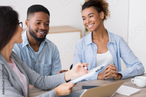 Gladful African American Couple Listening To Financial Counselor's Advice photo