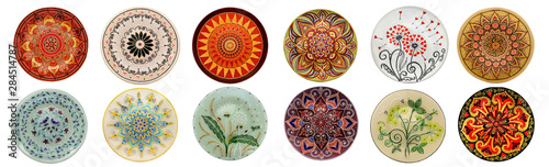 Set of decorative ceramic dishes hand-painted with acrylic paints floral pattern isolated on white background