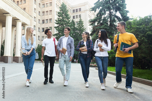Diverse students walking outside the college building
