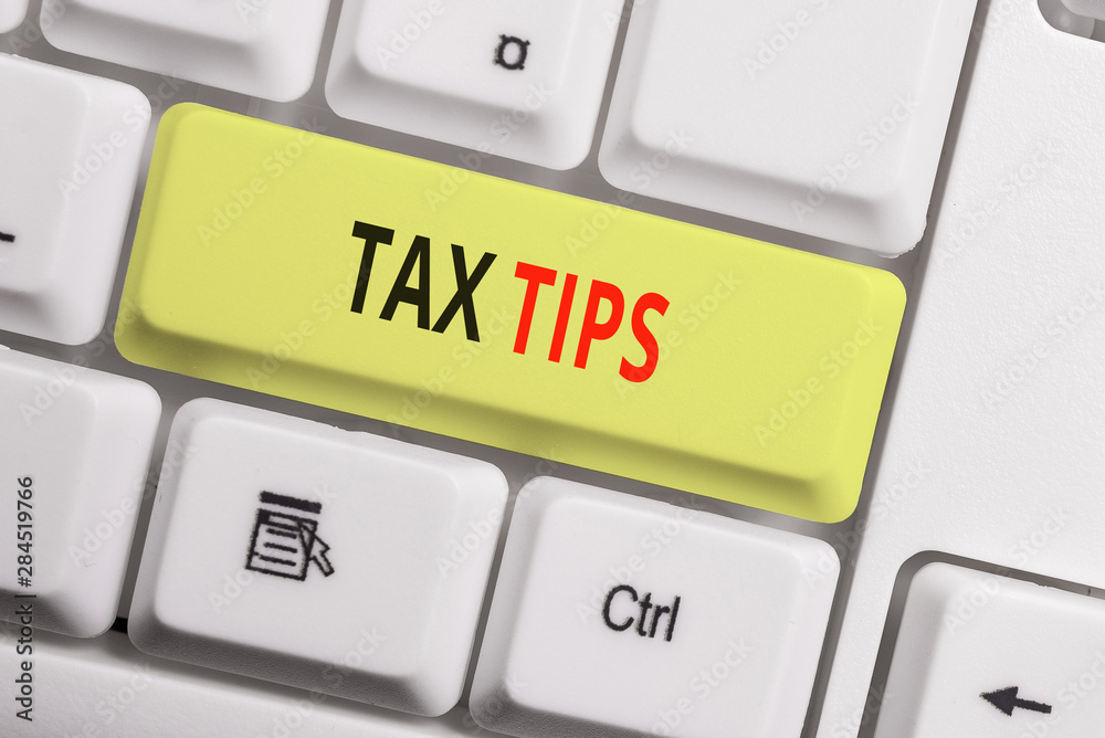 Text sign showing Tax Tips. Business photo showcasing compulsory contribution to state revenue levied by government White pc keyboard with empty note paper above white background key copy space Text sign showing Tax Tips. Business photo showcasing compulsory contribution to state revenue levied by government White pc keyboard with empty note paper above white background key copy space