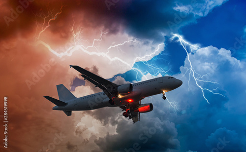 an airplane flies in bad weather and storm with lightning bolt