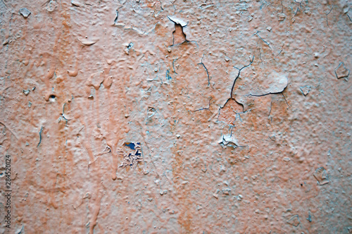 Painted wall with peeling paint. Texture wall covering, background. Outer wall on the street.