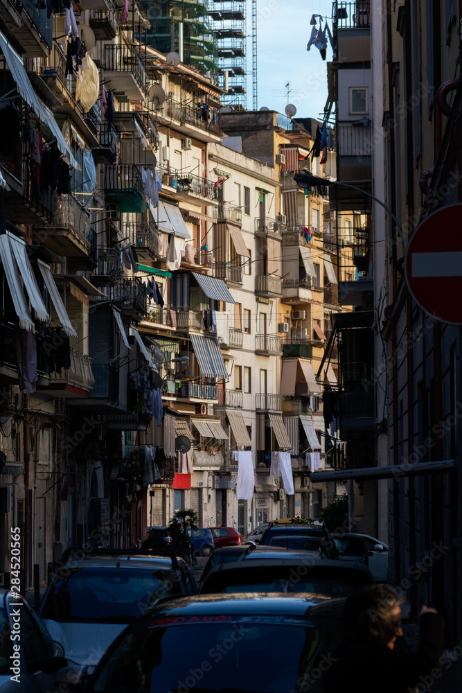 Naples old town in sunset. Traditional italian narrow alley. Naples downtown with small apartments and balconies.