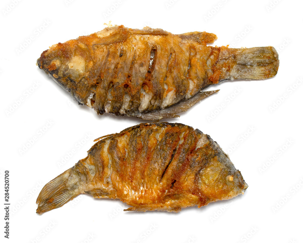 Fried fish on a plate, white background. Fried fish on a plate, white background.