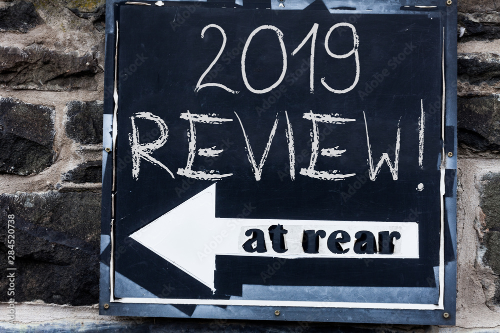 Fototapeta Word writing text 2019 Review. Business photo showcasing remembering past year events main actions or good shows Advertisement concept with empty copy space on the road sign