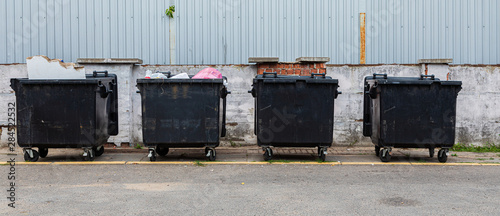 Black litter-bins on street, environmental pollution