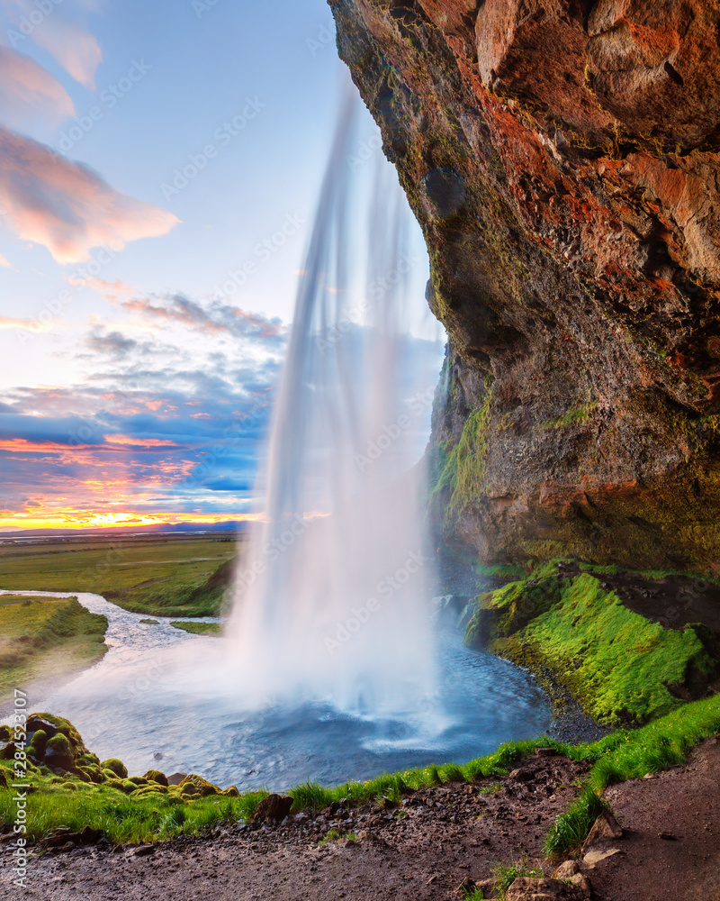 Instagram format 5x7 photo landscape in natural post-processing - Seljalandsfoss waterfall in Iceland, picturesque sunset scene. White nights summer time in Iceland.