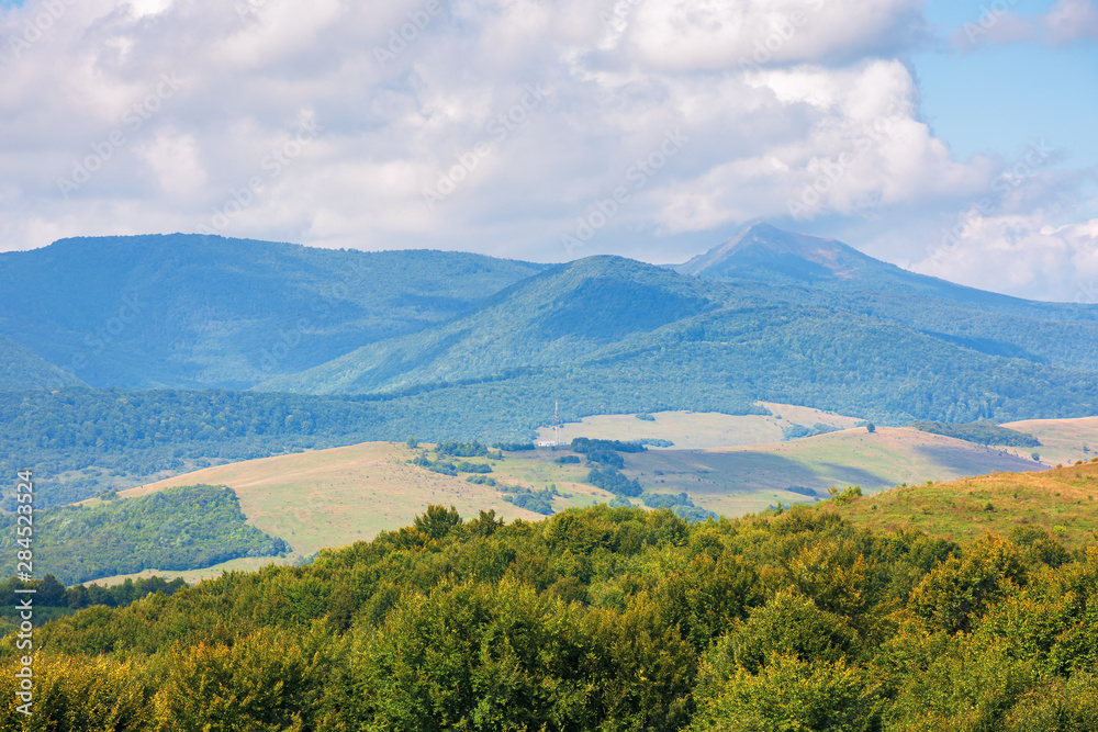 wonderful autumn mountain landscape. pikui peak of watershed ridge beneath clouds. wonderful carpathian countryside on a sunny day of september.