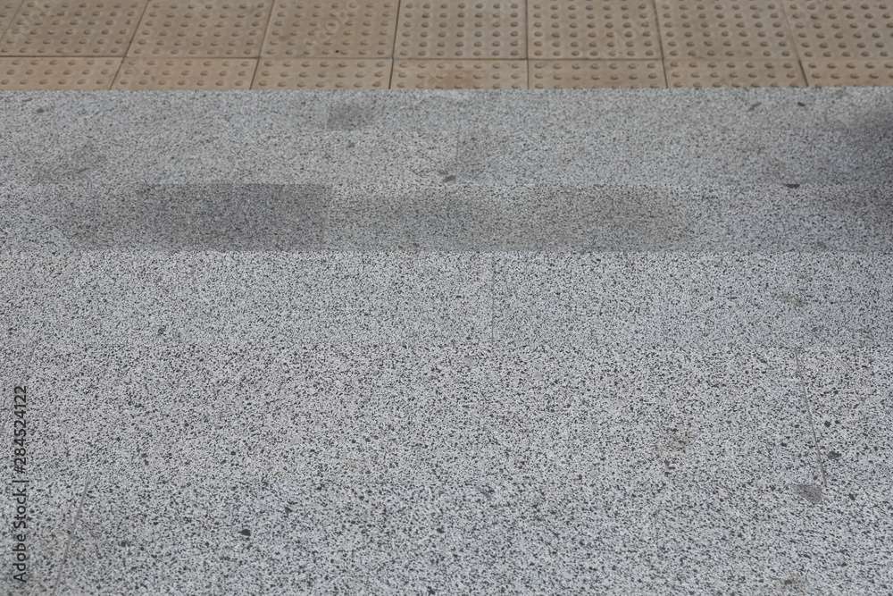 Fototapeta premium Gray granite tile with tactile paving