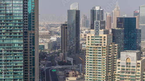 Aerial top view of Dubai Marina morning timelapse. Modern towers and traffic on the road