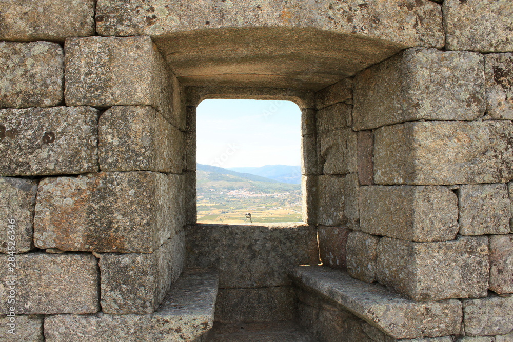 Large stone wall with a window. Mertola castle, Portugal 