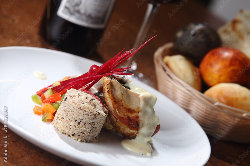 Roast chicken served with risotto and fresh vegetables with red wine. Roast chicken served with risotto and fresh vegetables with red wine.