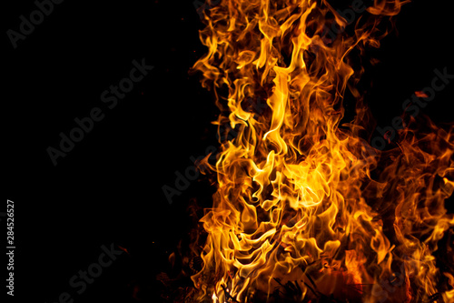 bright glowing flames on a black background on the right side of the picture