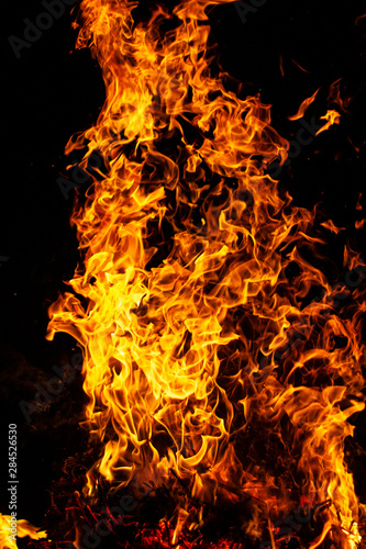 large powerful flame of bright fire on black background