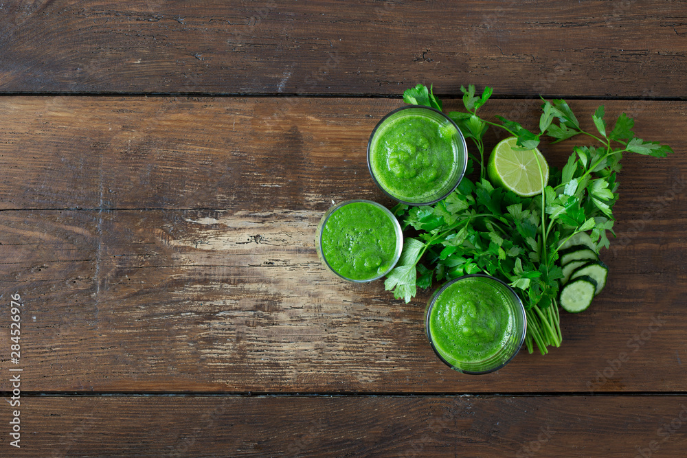 Detox diet concept. Green smoothie on a wooden background top view Detox diet concept. Green smoothie on a wooden background top view