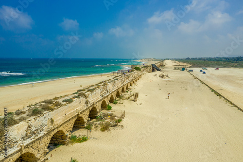 Ruins of the Roman Aqueduct in the sand dunes of the ancient city of Caesarea Maritima built by Herod the Great bringing water from the hill nearby to the city