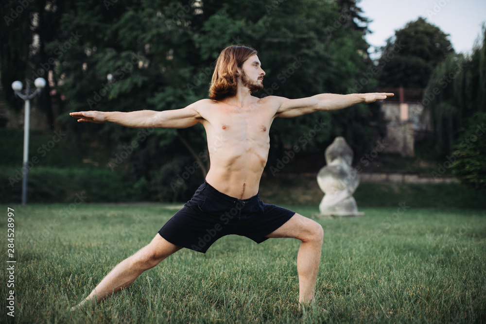 sporty man practicing yoga outdoor sporty man practicing yoga outdoor